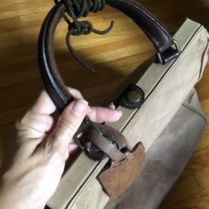 Brown canvas tote with leather details.